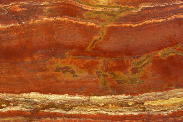 Natural stone in the colors of a lush lava with a white vein called Travertin Rosso