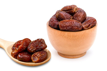 Closeup date palm fruits in wooden bowl isolated on white background. 