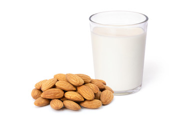 Close up glass of Almond milk and almond seeds isolated on white background. Healthy drinks...
