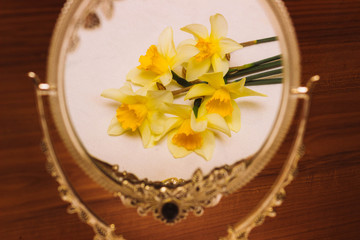Yellow flowers in the mirror reflection. Narcissus. Mirror. Nutere.