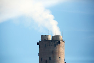 Power plant chimney with smokes