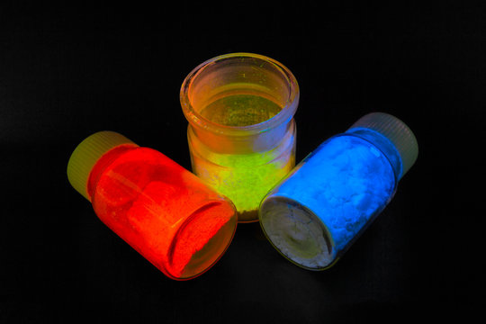 Photoluminescence Chemical Materials, Called Fluorescent. Powder Glows In The Dark Under UV Light Radiation Of Different Colors.