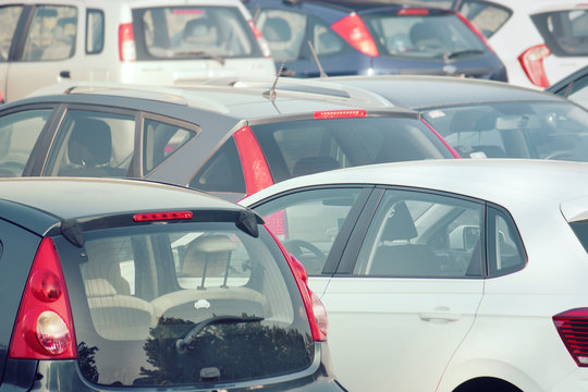 cars congestion in the parking, lot of vehicles parked outdoors
