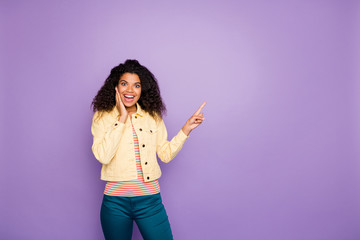 Portrait of amazed crazy afro american girl point index finger copyspace look unbelievable ads...