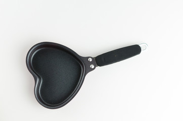 Heart shaped black metal pan isolated over white background