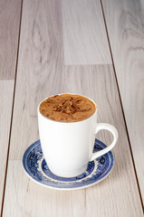 latte on home-made background and mug