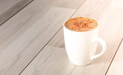 latte on home-made background and mug