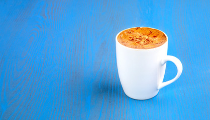 latte on home-made background and mug