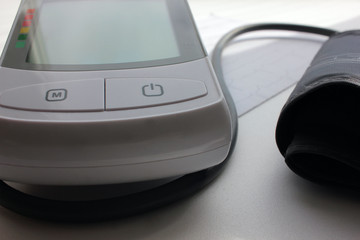 Close-up of electric digital device for measuring blood pressure Tonometer and cardiogram  on a white background
