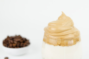 Dalgona frothy coffee trend Korean drink latte espresso with coffee foam on black background