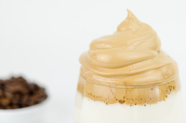 Dalgona frothy coffee trend Korean drink latte espresso with coffee foam on black background