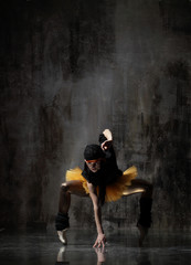 Young beautiful ballerina is posing in studio