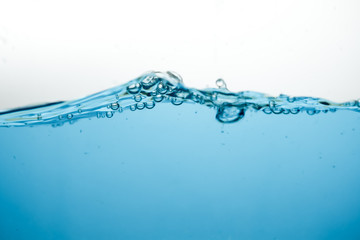 Wave and air bubbles on surface of water