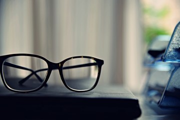 Glasses on the desk in an office.