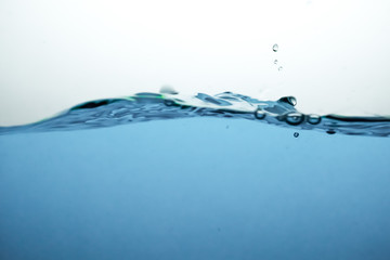 Wave and air bubbles on surface of water