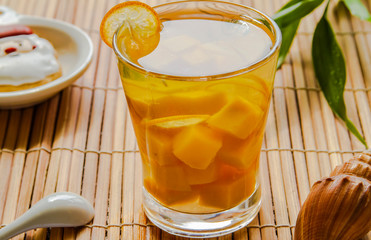Mango fruit tea in a glass close up