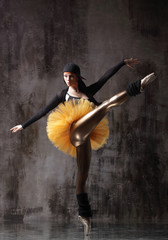 Fototapeta na wymiar Young beautiful ballerina is posing in studio