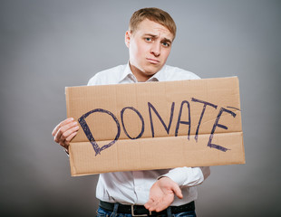 man holding Cardboard text a donate