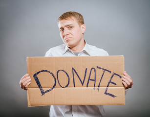 man holding Cardboard text a donate