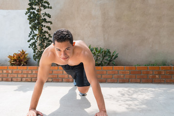 Fototapeta na wymiar A picture of a Hispanic athlete training at home