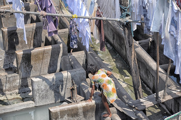 Mumbai, India-March 03,2013: Laundry Dhobi Ghat in Mumbai, people wash clothes on a city street. India's biggest wash.