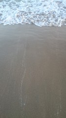 Sea wave over sand