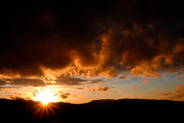 Sunset on Mountains Horizon Clouds Sunstar Sun star Glowing