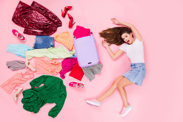 Top above high angle view full body profile side photo of astonished girl have travel trip fall her suitcase clothes fly scream lay wear white denim isolated pastel color background
