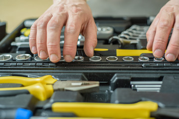 Worker chooses a tool for repair. Do it yourself. Close up