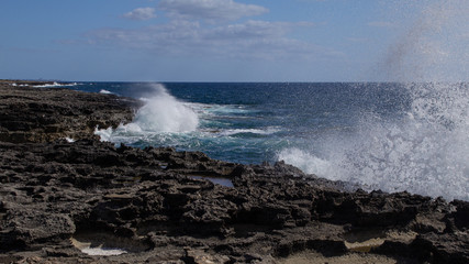 waves crash on the rocks of Favignana