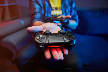 Gamer holding Gamepad, Controller or Videogame Joystick Console in hands. Close up, game concept