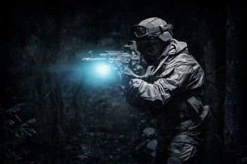 Portrait of a commando in the forest. The concept of military operations, international conflicts,...