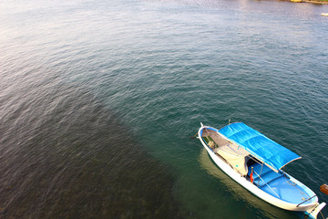 Blue white colored fishing boat on the sea.