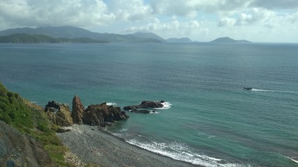 seascape, rocky beach, black cliffs and blue sea