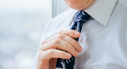 young man tie a tie