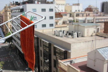 towels with colorful clothespins hanging on a white dryer overlooking the city