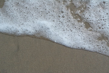 Sea wave over sand