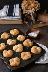 Freshly Baked Homemade Cloverleaf Rolls in Muffin Tin: Rustic, Dark Background
