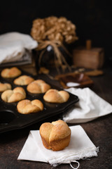 Freshly Baked Homemade Cloverleaf Rolls in Muffin Tin: One Roll on Napkin in Front; Rustic, Dark...