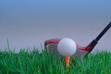 Golf ball and golf club in beautiful golf course at Thailand. Collection of golf equipment resting on green grass with green background
