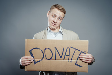 man holding Cardboard text a donate