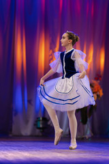 Young girls ballerina in a blue and white costume dancing performance on stage in a theater © Kozlik_mozlik