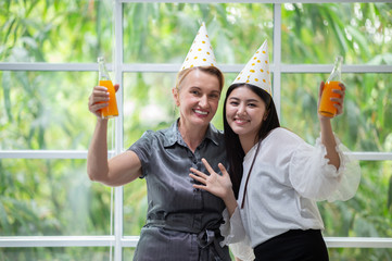 two female ecstasy drinking orange juice in party