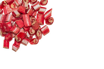 Big handful of red chilli lollipops with the image of pepper isolated on white background. Top view