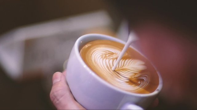 The barista is making coffee, Pour the Latte Art