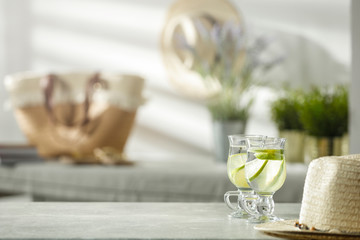 Mineral water on a wooden table in the morning sunlight with free space for an advertising product