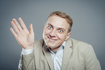 young man stupid expression waving