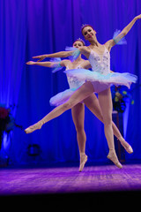 Young girl ballerina in a light blue dress tutu dancing performance of a ballet on stage in a theater © Kozlik_mozlik