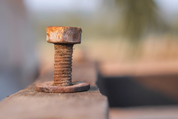 Orange rusty old bolts and nut made from steel close-up.