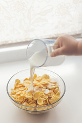 pouring milk into cereal